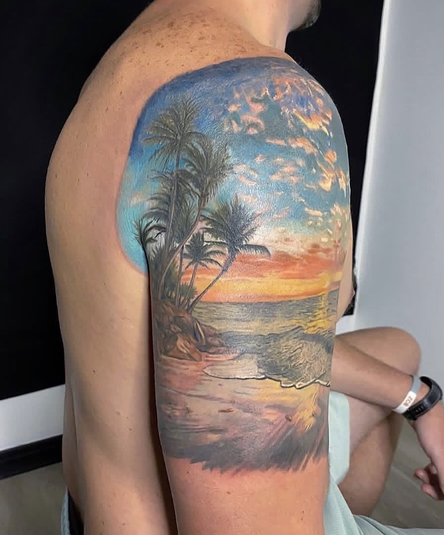 Tropical sunset color tattoo by Jake Bebout at Snafu Tattoo Studio in Wilmington NC